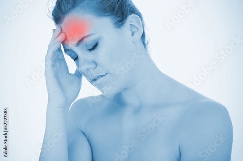 Photo: Stressed woman touching head in pain Stressed woman touching head in pain