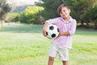 Little boy holding his football