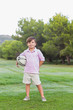 Smiling boy holding rugby ball