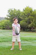 Little boy holding out rugby ball