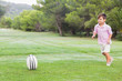Boy running to rubgy ball to kick it