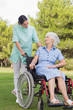 Nurse chatting with an elderly woman in wheelchair