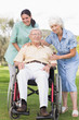 Man in wheelchair with his nurse and partner