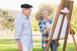 Elderly couple painting in the park