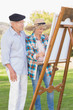 Old couple painting in the park