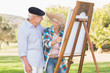 Happy couple painting in the park