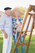 Portrait of elderly couple painting in the park