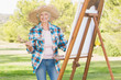 Portrait of elderly woman painting in the park