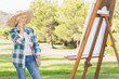 Old woman admiring her painting in the park