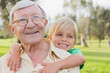 Smiling grandfather giving grandson a piggy back