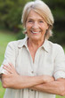 Happy blonde woman with arms crossed