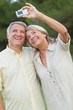 Older couple smiling for a photo they are taking themselves