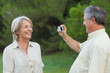Man taking a photo of his smiling partner