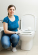 Photo : housewife cleaning toilet bowl with brush in bathroom housewife cleaning toilet bowl with brush in bathroom
