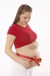 Photo: Pregnant woman with ribbon around belly Pregnant woman with ribbon around belly