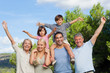 Multi-generation family portrait cheering and having fun