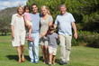 Multi-generation family portrait strolling through the park