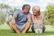 Happy older couple stretching in the park