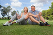 Portrait of older couple in sportswear with water bottles