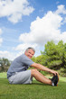 Mature man stretching in the park