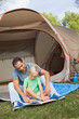 Father and son reading at the campsite