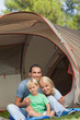 Portrait of son with parents on camping holiday