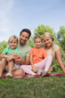 Portrait of happy family sitting on picnic blanket