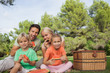 Happy family having a picnic and eating watermelon portrait
