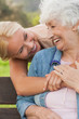 Elderly woman laughing with her adult daughter