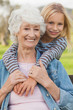 Elderly woman posing with her cute granddaughter