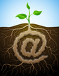 Vector concept of germination "at" symbol with roots and tuber