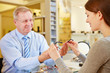 Young woman buying glasses at optician