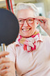 Nearsighted senior woman with new glasses
