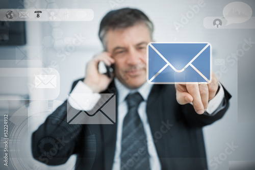 Photo: Businessman selecting email application on touchscreen Businessman selecting email application on touchscreen