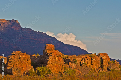 Photo: Rocks in evening light with mountain and cloud Rocks in evening light with mountain and cloud