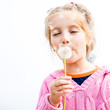 girl blowing dandelion