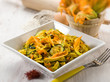 Foto: pasta with zucchinis flower and saffron, selective focus pasta with zucchinis flower and saffron, selective focus