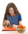 smiling schoolgirl cut tomatoes for salad