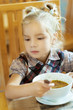 Girl-preschooler eats a tasty meal