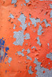 flaking old paint on a stainless steel surface
