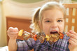 beautiful smiling girl eating kebab