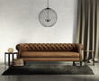 Illustration: Classic brown leather sofa, dark rug with stools, ceiling lamp Classic brown leather sofa, dark rug with stools, ceiling lamp