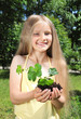 Foto: Little girl holding a seedling in cupped hands Little girl holding a seedling in cupped hands