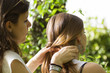 Two Young Women settle their hair outdoors