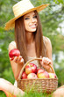 Photo: Beautiful woman in the garden with apples Beautiful woman in the garden with apples