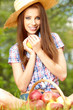 Beautiful woman in the garden with apples