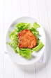 Glazed pork chop on lettuce leaves