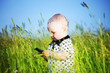Foto: boy in grass call by phone boy in grass call by phone