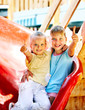 Photo: Children move out to slide in playground. Children move out to slide in playground.