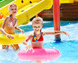 Photo: Child on water slide at aquapark. Child on water slide at aquapark.